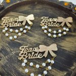 handcrafted Team Bride brooches featuring pearl embellishments, perfect for wedding favors and bridesmaid gifts