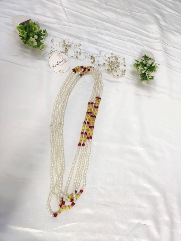 Milni Mala features lustrous pearls combined with vibrant yellow and red beads, perfect for welcoming guests at wedding ceremonies. Ideal for the Nikah ceremony, it also serves as a stunning wedding favor