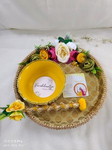 Beautiful golden Haldi ceremony platter with lace and pearl detailing, complemented by yellow flowers. or Haldi, Mehndi, or Nikah ceremonies, it adds a touch of elegance to your wedding rituals and serves as a charming wedding favor