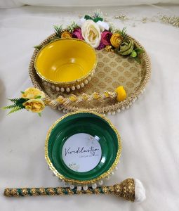 Golden Haldi ceremony platter with intricate lacework, pearl accents, and bright yellow flowers for Haldi, Mehndi, or Nikah ceremonies, it adds a touch of sophistication to your wedding rituals and serves as a delightful wedding favor
