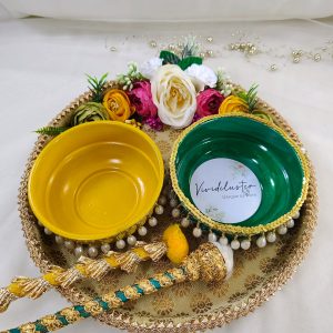 Golden Haldi ceremony platter with intricate lace and pearl detailing, adorned with yellow flowers and traditional embellishments