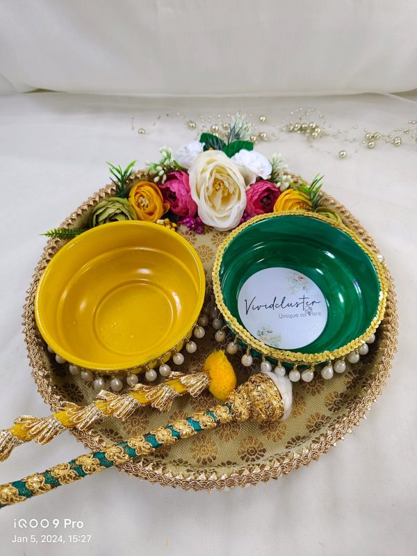 Golden Haldi ceremony platter with intricate lace and pearl detailing, adorned with yellow flowers and traditional embellishments