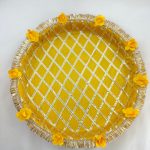 Decorative yellow and gold steel platter featuring a lattice pattern, golden trims, yellow flower accents, and a centerpiece round box for Haldi and Henna ceremonies This platter is a wonderful way to add a touch of tradition and elegance to your special day