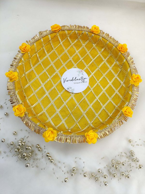 Decorative yellow and gold steel platter featuring a lattice pattern, golden trims, yellow flower accents, and a centerpiece round box for Haldi and Henna ceremonies This platter is a wonderful way to add a touch of tradition and elegance to your special day