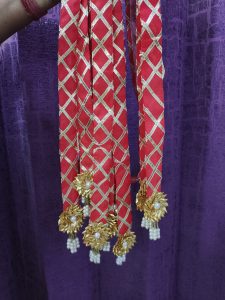 Dupatta-style pearl welcome milni mala featuring red and gold accents with intricate pearl and floral embellishments, perfect for nikah ceremony welcome mala, wedding favor, and guest mala