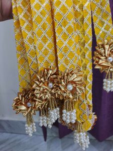 Handcrafted moti haar with a yellow and gold lattice design, adorned with golden flowers and pearls, ideal for baaratis mala, punjabi milni gift, and decorative mala
