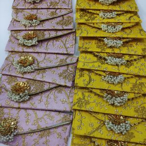 yellow and pink shagun lifafa adorned with pearls and gold detailing, for bridal showers, baby showers, and giveaway gifts