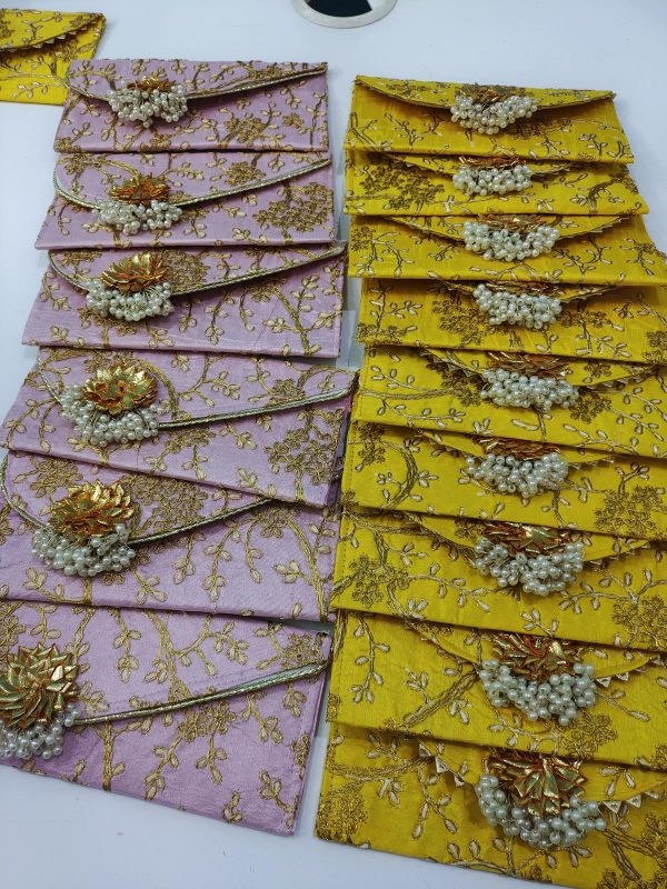 yellow and pink shagun lifafa adorned with pearls and gold detailing, for bridal showers, baby showers, and giveaway gifts