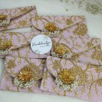 Handcrafted pink pearl envelope with golden floral embroidery, ideal for nikah ceremony favors