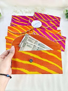 handcrafted shagun lifafa in rich pink and orange, featuring intricate gota, perfect for shagun ceremony giveaways and bridal shower favors