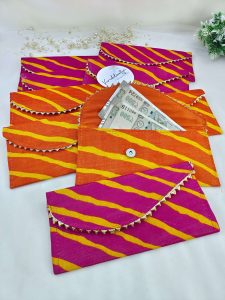 Handcrafted embroidery envelopes in vibrant pink and orange hues, perfect for nikah ceremony envelope, wedding favor, shagun giveaway gift, and shagun lifafa, adorned with delicate golden trim