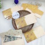 Designer shagun envelopes with rich golden detailing, perfect for wedding and engagement ceremonies