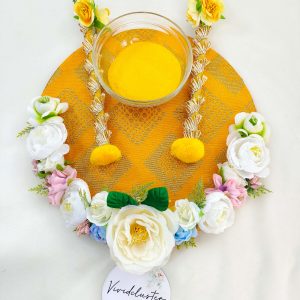 Beautifully decorated Haldi platter featuring white, yellow, and pink flowers for traditional Haldi rituals and wedding decor pre-wedding functions
