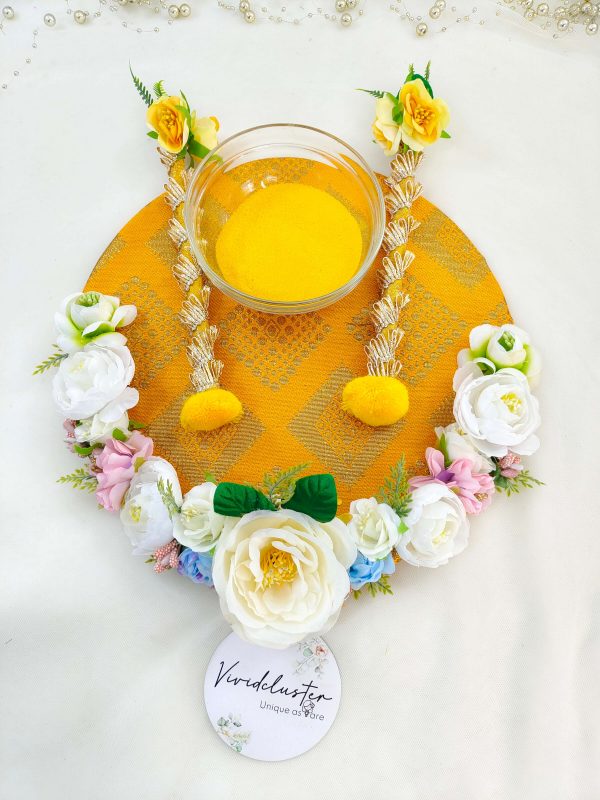 Beautifully decorated Haldi platter featuring white, yellow, and pink flowers for traditional Haldi rituals and wedding decor pre-wedding functions