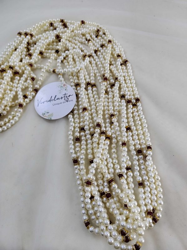 Intricate pearl garland featuring gold and maroon beads. Perfect for welcoming baaratis, this decorative flower milni mala