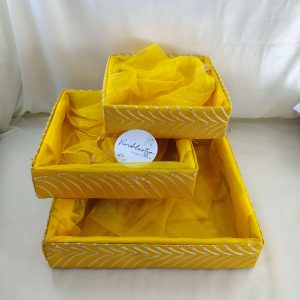 Beautifully handcrafted shagun tray made of MDF and net, ideal for sangeet and engagement ceremonies. Perfect for return gifts, guest giveaways, and baby showers. This vibrant yellow marriage tray