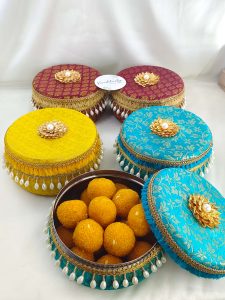 Vibrant brocade wedding favor boxs with luxurious gold and pearl decorations for bridesmaid's gifts, guest gifts, or as a special wedding favor laddu boxes