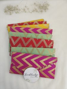 handcrafted shagun lifafa in rich pink and orange, featuring intricate gota, perfect for shagun ceremony giveaways and bridal shower favors