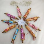 A variety of colorful roller envelopes designed for shagun ceremonies, nikah ceremonies, and wedding favors. These envelopes are adorned with intricate designs and golden trims