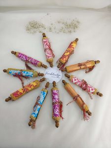 A variety of colorful roller envelopes designed for shagun ceremonies, nikah ceremonies, and wedding favors. These envelopes are adorned with intricate designs and golden trims