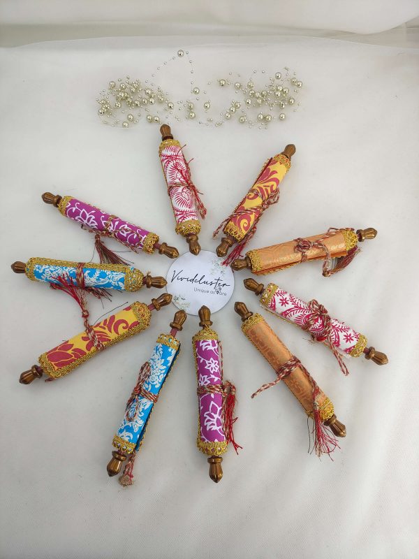 A variety of colorful roller envelopes designed for shagun ceremonies, nikah ceremonies, and wedding favors. These envelopes are adorned with intricate designs and golden trims