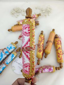 roller shagun lifafa featuring ornate designs and golden trims, suitable for bridal showers, baby showers, and wedding favors. The elegant craftsmanship makes these envelopes a charming addition to any shagun ceremony.