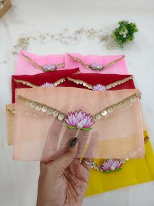 Beautifully crafted lotus net shagun envelopes adorned with a delicate lotus flower and golden trim, ideal for shagun giveaways and bridal showers