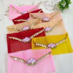 Set of lotus net shagun envelopes in various shades, decorated with golden lace and lotus motifs, perfect for wedding favor giveaways