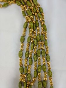green beaded mala necklace with golden accents, perfect for traditional bridal jewelry at weddings. wedding gift for your bridesmaid for ceremonies