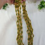 Indian wedding milni featuring a handcrafted green beaded mala necklace with latest gold accents for your haldi mehendi ceremony to look different in functions.