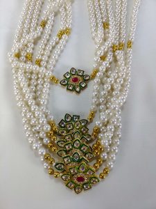 Handcrafted bridal necklace featuring white pearls, golden beads, and a detailed floral pendant, ideal for bridesmaid gifts and wedding favors, Use this beautiful mala on your brothers or cousins wedding ceremony and look gorgeous.