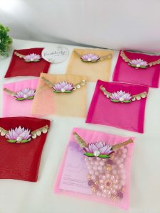Colorful lotus net shagun envelopes adorned with gold lace and lotus flower, perfect for shagun lifafa and wedding ceremony giveaways.