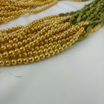 Handcrafted wedding necklace featuring a stunning green beaded bridal mala with intricate golden details for your bride to look gorgeous in her haldi mehandi ceremony.