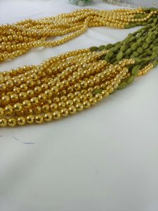 Handcrafted wedding necklace featuring a stunning green beaded bridal mala with intricate golden details for your bride to look gorgeous in her haldi mehandi ceremony.