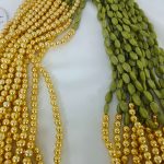 A beautifully detailed Welcome Milni Mala Moti Haar featuring Elachi and green and gold beads for weddings, guest welcomes, and bridesmaid gifts