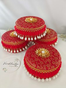 A set of five red round laddu boxes perfect for storing shagun laddus and make wonderful gifts
