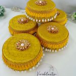 Laddu Boxes A collection of yellow round laddu boxes for shagun laddus or as special gifts for baratis and bridesmaids