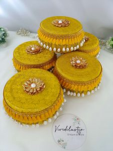 Laddu Boxes A collection of yellow round laddu boxes for shagun laddus or as special gifts for baratis and bridesmaids