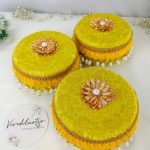 Laddu Boxes A collection of yellow round laddu boxes for shagun laddus or as special gifts for baratis and bridesmaids