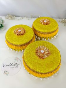 Laddu Boxes A collection of yellow round laddu boxes for shagun laddus or as special gifts for baratis and bridesmaids
