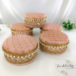 A set of colorful wedding laddu shagun boxes adorned with gold embroidery and pearls, showcasing their elegant design and stainless steel interior shagun boxes, a memorable return gift