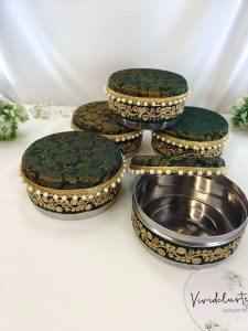 Beautifully decorated laddu shagun boxes in green color featuring gold embroidery and a stainless steel interior, ideal for giveaway favor guests gift