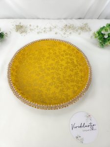 Decorative yellow Haldi ceremony platter with pearl-trimmed bowls and floral accents to add a touch to your wedding rituals haldi mehndi ceremony platter