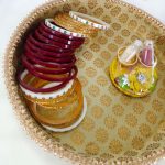 Intricate gold-patterned platter with a finely detailed border deal for ceremonial use presenting bangles and chuda ceremony platter celebrations with this elegant and versatile platter