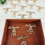 a charming Ladkewale brooch, embellished with pearls. The brooch is elegantly designed, making it an ideal wedding favor or coat accessory for groom side badges and baaratis