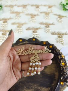 sophisticated Ladkewale brooch with pearl embellishments. The brooch features a refined design with delicate pearls, making it an ideal wedding favor and coat accessory