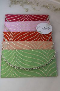 Set of colorful shagun cash envelopes adorned with gold embroidery and pearls, ideal for wedding favors and bridal showers