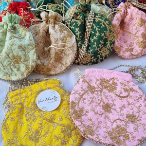 embroidery potli bags are designed to complement your wedding festivities. Available in a variety of colors, these bags feature detailed gold embroidery, making them perfect for bridal gifts, bridesmaid gifts, and wedding favors.
