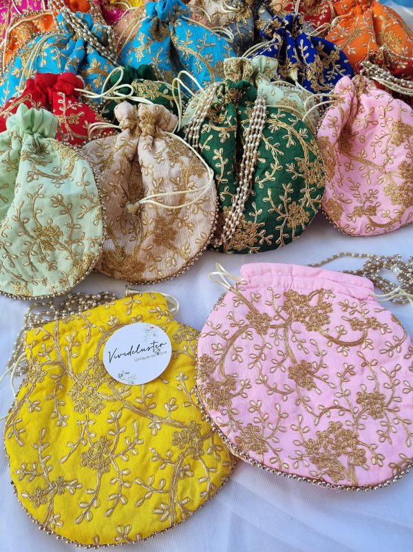 embroidery potli bags are designed to complement your wedding festivities. Available in a variety of colors, these bags feature detailed gold embroidery, making them perfect for bridal gifts, bridesmaid gifts, and wedding favors.