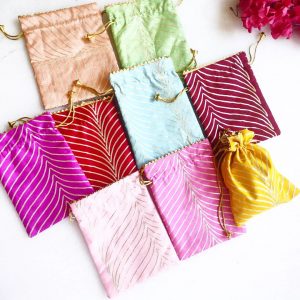 A set of beautifully crafted Lehariya Printed Potlis in an array of colors, showcasing traditional patterns. Perfect for wedding gift hampers, nikah ceremony favors, and bridesmaids gifts